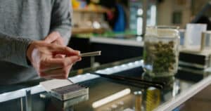 A budtender works inside of a retail cannabis shop in Oregon.